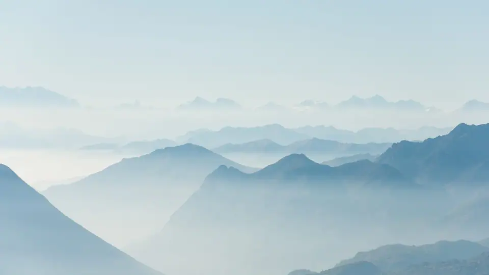 Layers of quiet mountain ridges fading into the mist