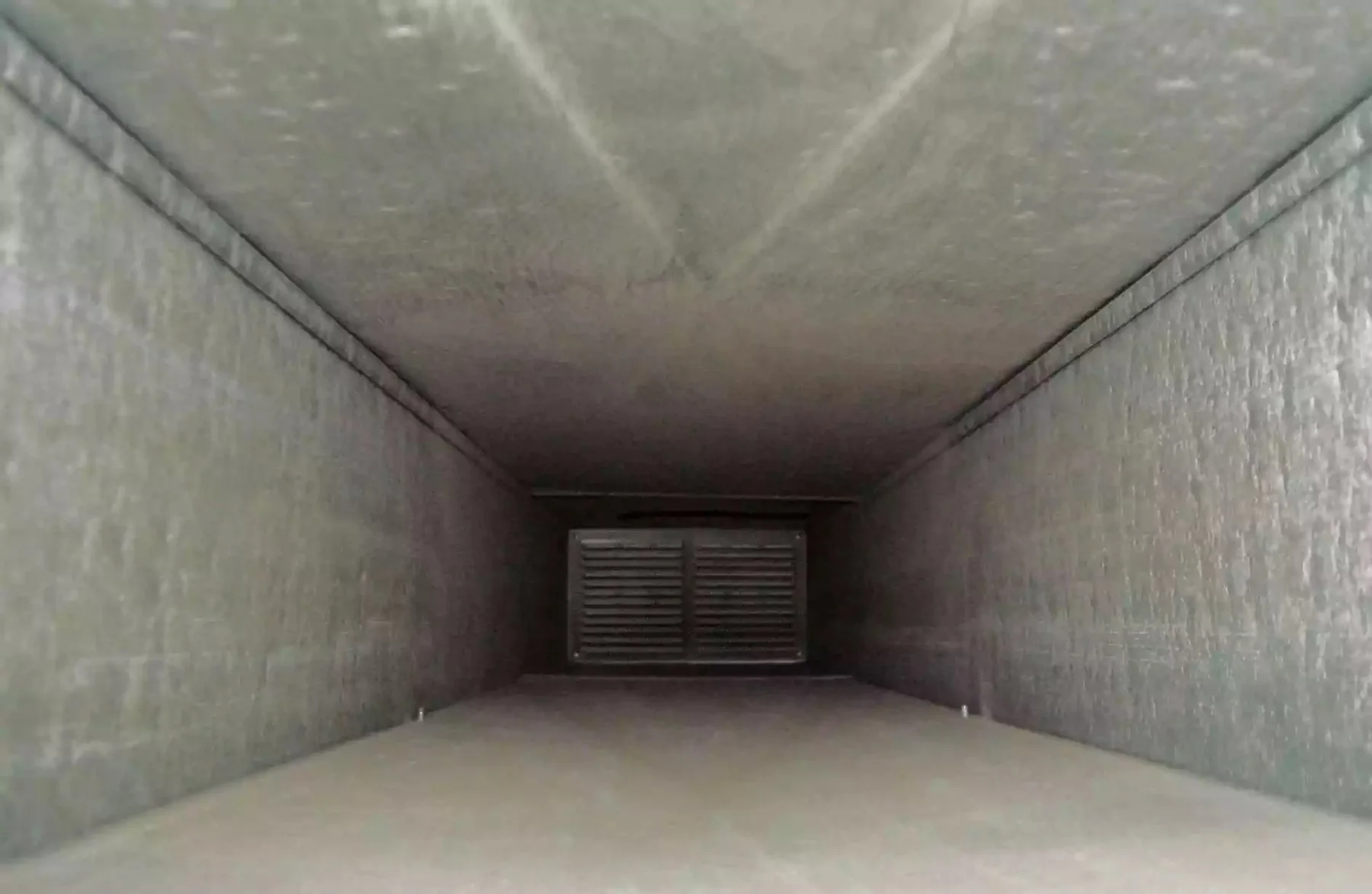 Photograph looking down a clean metal air duct
