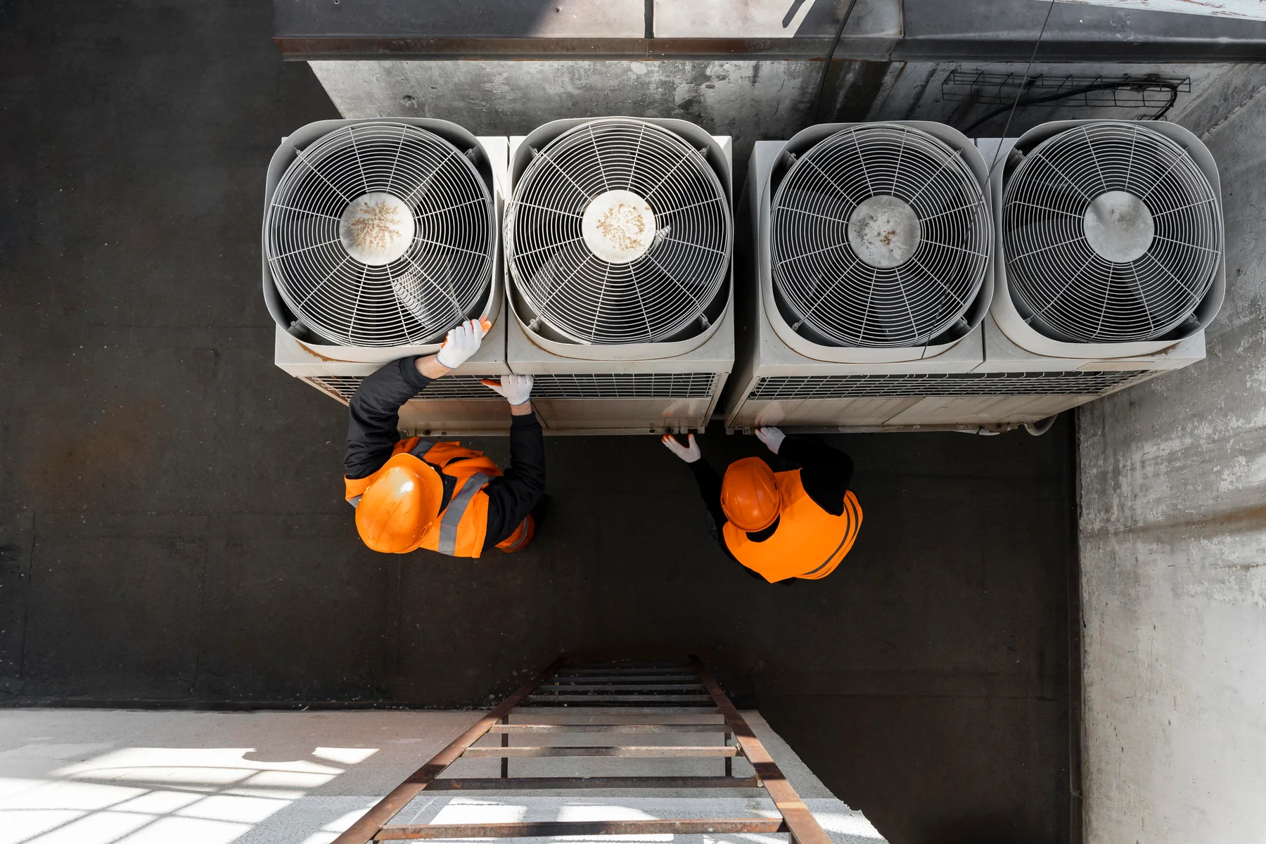 Technicians working on HVAC system equipment